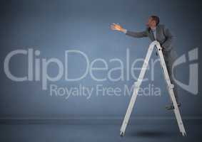 Businessman on ladder stretching his hand to reach