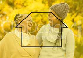 Mother and daughter smiling in the park with house outline
