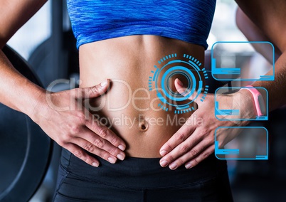 Fit woman showing abdominal muscles and fitness interface in background