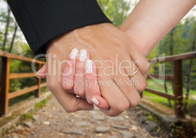 Married couple holding hands in park