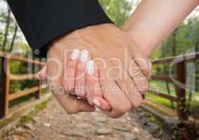 Married couple holding hands in park