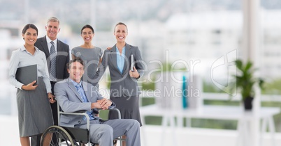 Group of businesspeople smiling at camera in the office