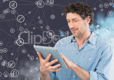 Man using digital tablet against connecting icons