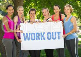 Portrait of group of happy women holding placard with text workout