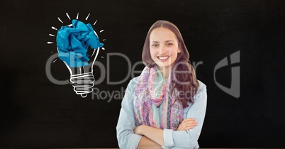 Portrait of a smiling woman with crumbled paper on a drawn light bulb in background