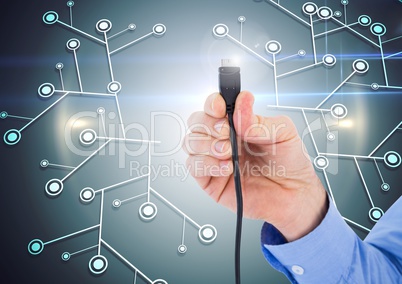Hand holding a cable with light flare against circuit background