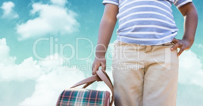 Man carrying a bag against sky in background