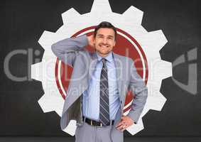 Smiling businessman standing with hand on hip