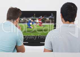 Rear view of men watching football match on television