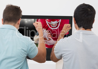 Friends cheering while watching american football match on television
