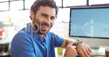 Portrait of smiling man using smart watch