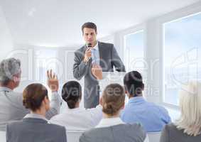 Businessman speaking on microphone in meeting
