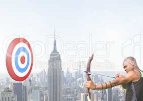 Athlete aiming at the target board against cityscape in background