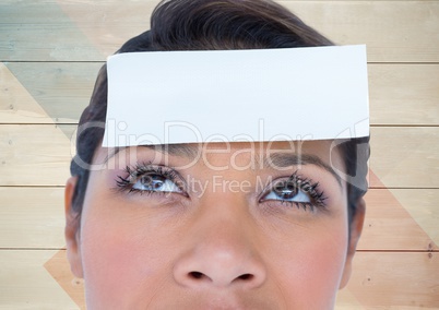 Woman with blank sticky note on forehead