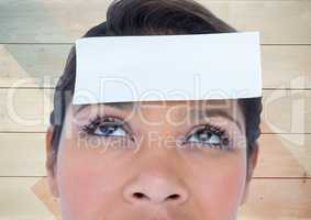 Woman with blank sticky note on forehead