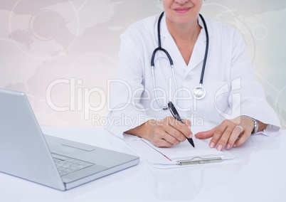 Doctor writing on clipboard on desk with digital world map in background
