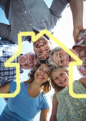 Multigeneration family forming a huddle with house outline