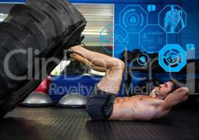 Fit man performing leg press exercise in gym