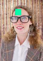 Businesswoman with sticky note on her forehead