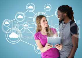 Couple holding digital tablet against digitally generated background