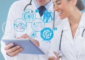 Doctors using digital tablet with multiple models interface in clinic