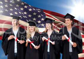 Group of people in graduation gown standing against American flag