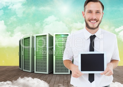 Businessman holding digital tablet against server systems in sky
