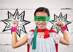 Portrait of kid in red cape and green mask standing with fist