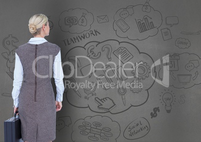 Businesswoman looking at business plan concept on blackboard