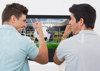 Friends cheering while watching soccer match on television