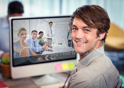 Businessman having video call with colleagues on desktop computer