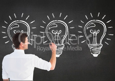 Man drawing electric bulb on blackboard