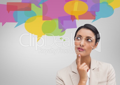 Businesswoman looking at speech bubble icons