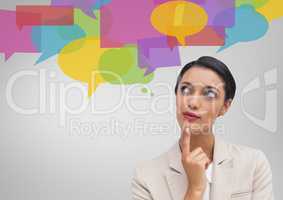 Businesswoman looking at speech bubble icons
