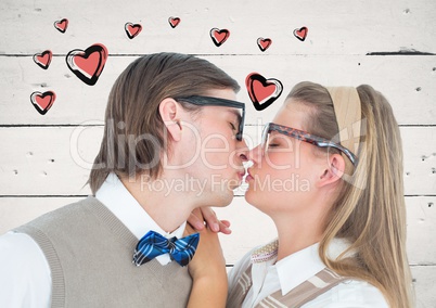 Couple kissing each other against heart graphics