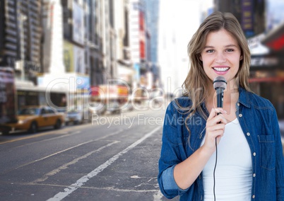 Portrait of beautiful woman singing on microphone on street
