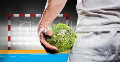 Athlete holding handball against stadium in background