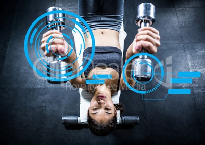 Fit woman exercising with dumbbells in gym