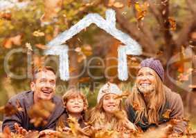 Family overlaid with house shape lying on dry leaves in park