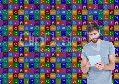 Man using digital tablet with various icons in background