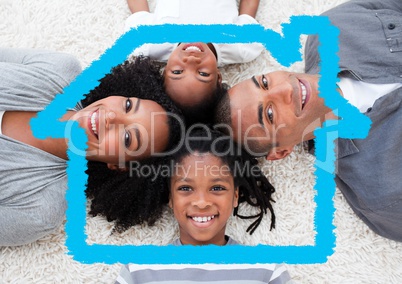 Happy family lying on rug overlaid with house shape