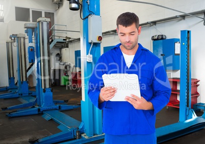 Automobile mechanic holding clipboard