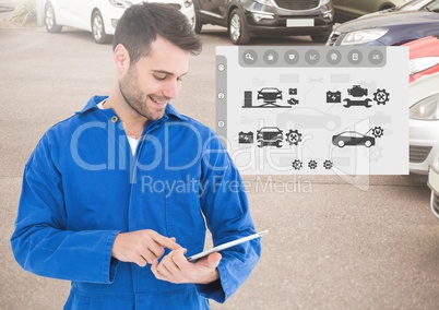Mechanic using digital tablet with car mechanic interface in background