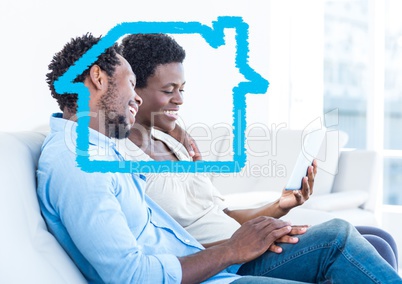 Home outline with couple using digital tablet at home