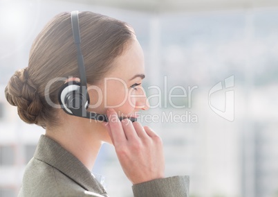 Customer service executive in headset talking with a client