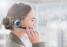 Customer service executive in headset talking with a client