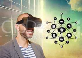 Man using virtual reality headset with digitally generated icons