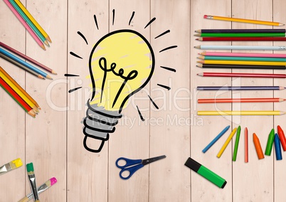 Innovative bulb surrounded by stationery on wooden background