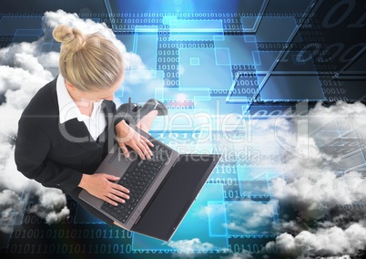Digital composite image of businesswoman working on laptop