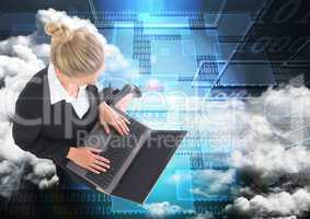 Digital composite image of businesswoman working on laptop